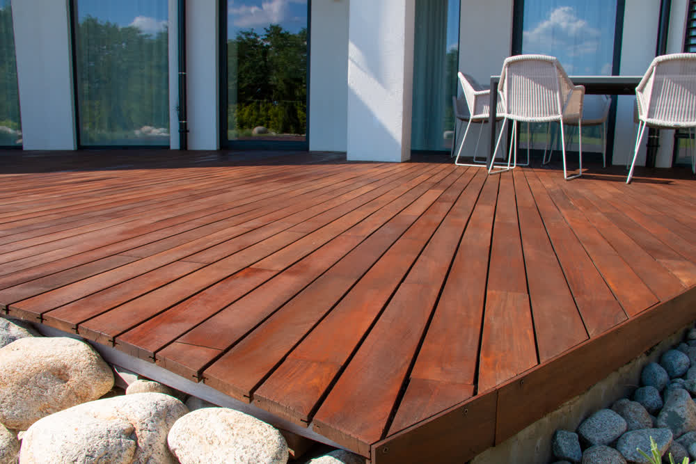 Angled decking area surrounded by stone garden