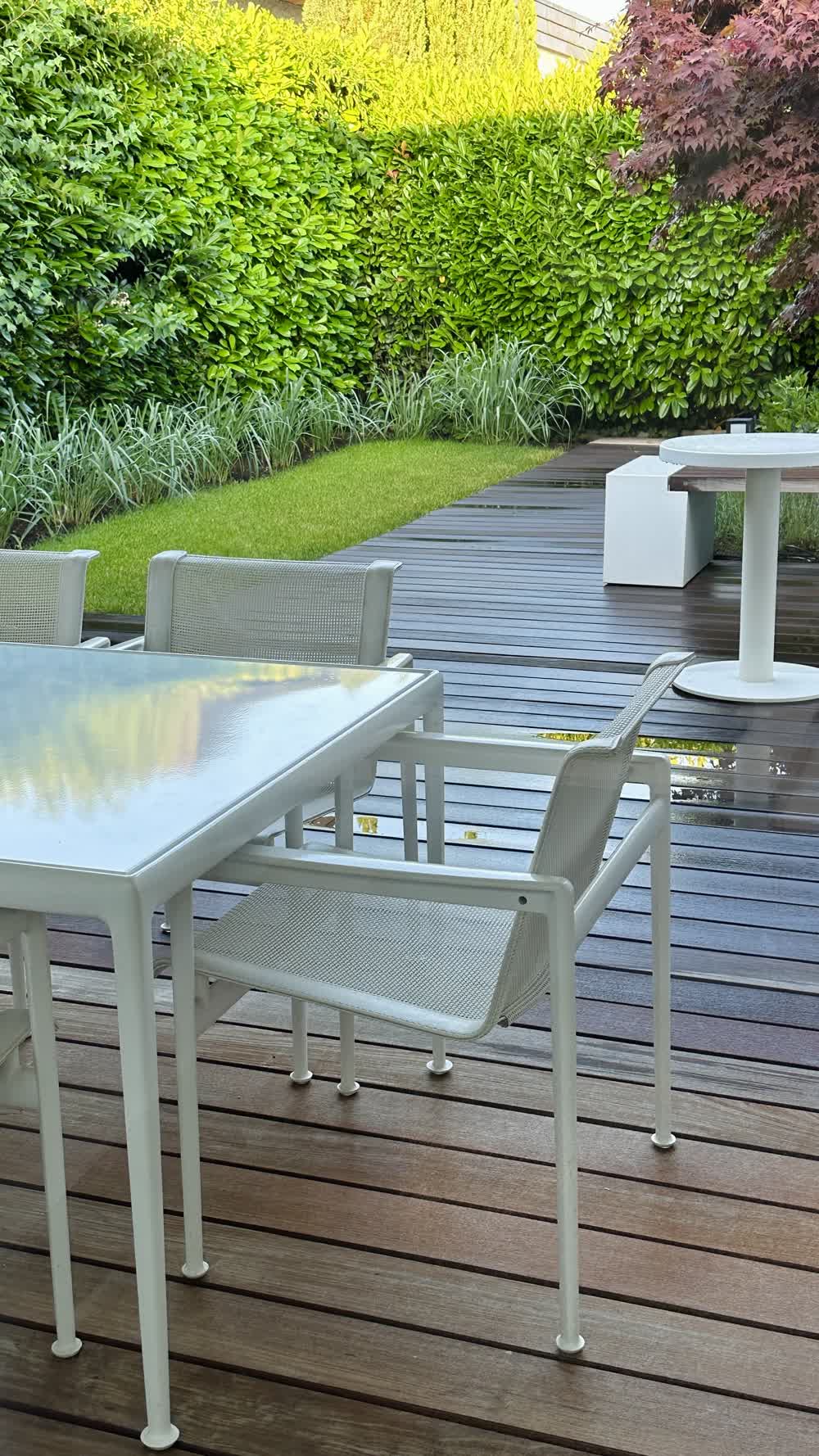 Backyard deck with built-in seating in tiny garden