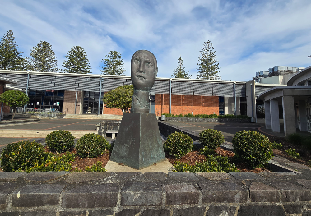 Statue and Buxus balls in planter at Sacred Heart College