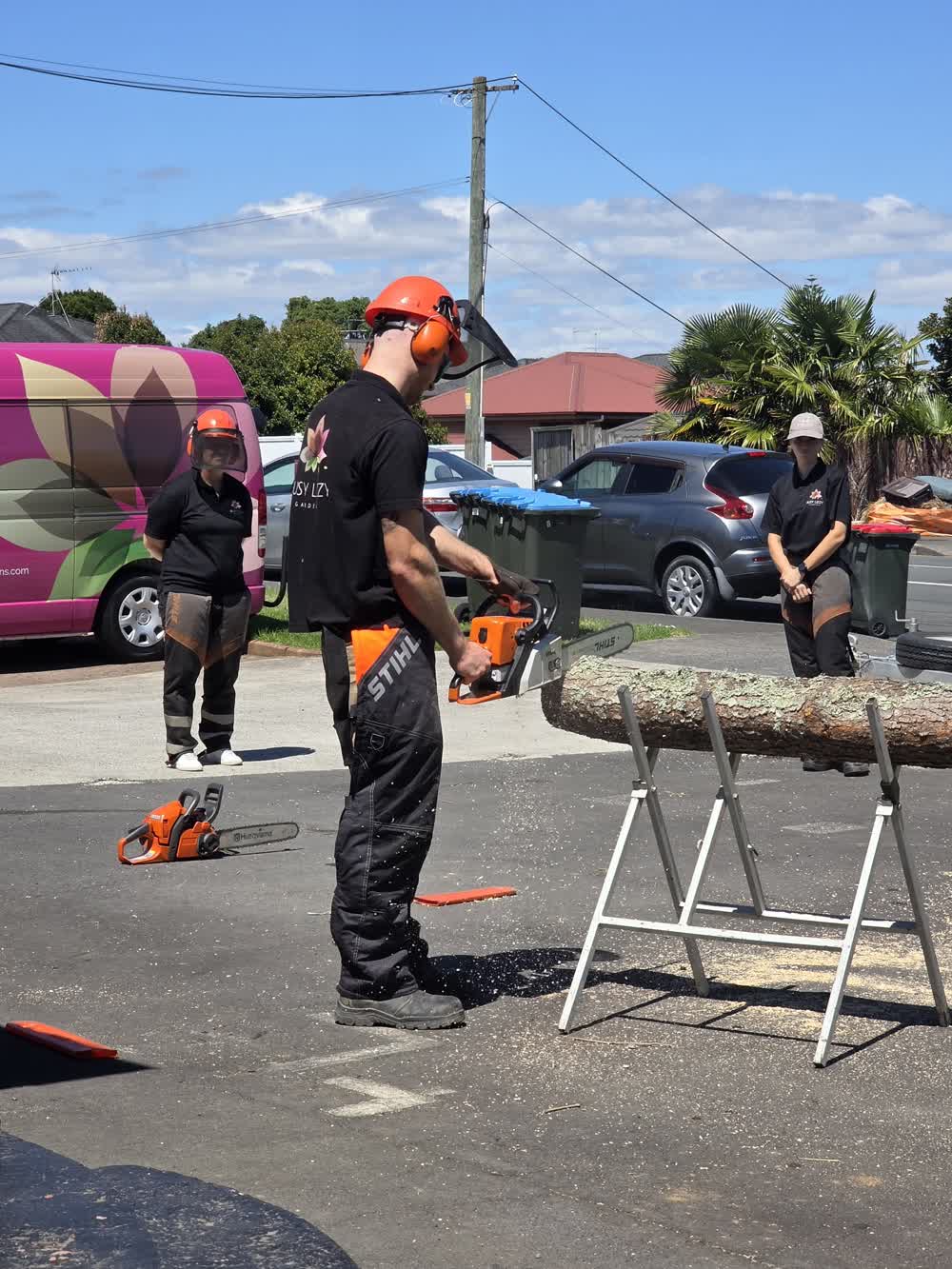 Chainsaw training session instructors watch arborist from a safe distance
