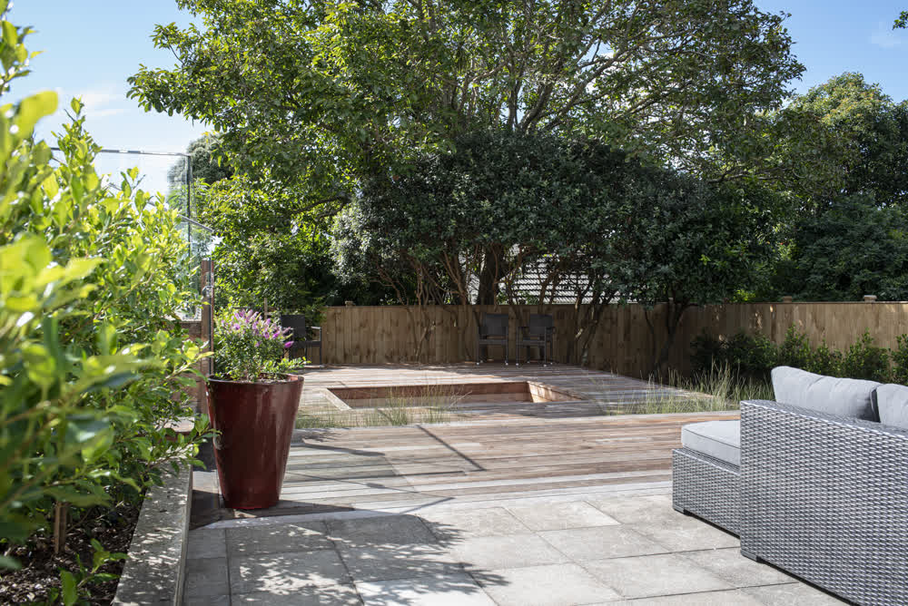 Outdoor entertainment area with connected paved and decked zones